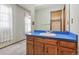 Bathroom features a wood vanity with a blue countertop and white sink at 10208 E Jewell Ave # 18, Aurora, CO 80247