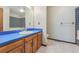 This bathroom features a blue-tiled bathtub and shower combination and a wood vanity at 10208 E Jewell Ave # 18, Aurora, CO 80247