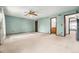 Spacious bedroom with plush carpeting, ceiling fan, and en-suite bathroom access at 10208 E Jewell Ave # 18, Aurora, CO 80247