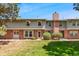 Charming two-story townhouse with red brick and green siding with manicured front lawn at 10208 E Jewell Ave # 18, Aurora, CO 80247