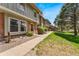 Attractive townhouse featuring a concrete sidewalk, well-maintained lawn, and lush green shrubs at 10208 E Jewell Ave # 18, Aurora, CO 80247
