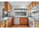 Bright kitchen boasts natural wood cabinets, stone countertops, and modern appliances at 10208 E Jewell Ave # 18, Aurora, CO 80247