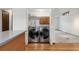 Convenient laundry closet with modern washer and dryer units adjacent to the kitchen at 10208 E Jewell Ave # 18, Aurora, CO 80247