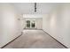 Cozy living room with neutral carpeting and a view of a backyard through a window at 10208 E Jewell Ave # 18, Aurora, CO 80247