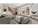 Bright living room with neutral tones, plush carpeting, and a large window at 10208 E Jewell Ave # 18, Aurora, CO 80247