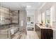 Well-lit bathroom with an open door to the bedroom, a glass shower, and sleek fixtures at 4200 W 17Th Ave # 211, Denver, CO 80204