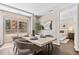 Bright dining room features balcony access, a modern table, and an open layout at 4200 W 17Th Ave # 211, Denver, CO 80204