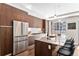 Gorgeous kitchen features a large island, stainless steel appliances, and modern lighting at 4200 W 17Th Ave # 211, Denver, CO 80204