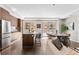 Modern living room and kitchen feature stainless appliances, granite counters, and balcony at 4200 W 17Th Ave # 211, Denver, CO 80204