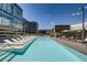 Modern building featuring a large outdoor swimming pool with sundeck and lounge chairs at 4200 W 17Th Ave # 211, Denver, CO 80204