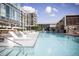 Modern apartment building featuring a large outdoor swimming pool with sundeck and lounge chairs at 4200 W 17Th Ave # 211, Denver, CO 80204