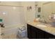 Bright and clean bathroom featuring a tub, shower, and vanity with granite countertop at 1851 S Dunkirk St # 201, Aurora, CO 80017