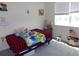 Comfortable bedroom with a window, toys, and a bed with a colorful blanket at 1851 S Dunkirk St # 201, Aurora, CO 80017