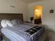 An open bedroom with a view into the attached Primary bathroom at 1851 S Dunkirk St # 201, Aurora, CO 80017