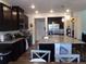 Well-equipped kitchen with stainless steel appliances, dark cabinetry, and granite countertops at 1851 S Dunkirk St # 201, Aurora, CO 80017