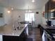 Bright, open kitchen featuring an island with a sink and stainless steel appliances at 1851 S Dunkirk St # 201, Aurora, CO 80017