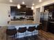 Modern kitchen with a large island featuring granite countertops and seating for four at 1851 S Dunkirk St # 201, Aurora, CO 80017