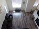 Top-down view of the inviting living room with open floor plan, wood floors, fireplace and comfortable furniture at 1851 S Dunkirk St # 201, Aurora, CO 80017