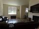 Spacious living room with fireplace, TV, wood floors, comfortable leather furniture and lots of natural light at 1851 S Dunkirk St # 201, Aurora, CO 80017