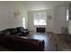 Bright living room with vaulted ceiling, wood floors, large window, and comfortable seating arrangement at 1851 S Dunkirk St # 201, Aurora, CO 80017