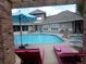 Inviting community pool and lounge area with chairs and a sun umbrella at 1851 S Dunkirk St # 201, Aurora, CO 80017