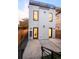 Modern townhome exterior featuring a backyard with a private patio, contemporary siding, and sleek design at 3435 W 17Th Ave, Denver, CO 80204