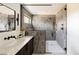 Bathroom with a tiled shower, a glass door, and a dark vanity at 3435 W 17Th Ave, Denver, CO 80204