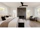 Bright bedroom featuring a gray fireplace, wood floors, and multiple windows at 3435 W 17Th Ave, Denver, CO 80204