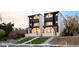 Modern townhomes featuring a striking black and white exterior design with balconies and landscaped front yards at 3435 W 17Th Ave, Denver, CO 80204