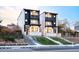 Modern townhomes featuring a striking black and white exterior design with balconies and landscaped front yards at 3435 W 17Th Ave, Denver, CO 80204