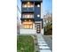 Modern home with black trim, white brick, and a concrete staircase at 3435 W 17Th Ave, Denver, CO 80204