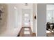 Bright hallway with hardwood floors, white walls, and a modern front door with glass panels at 3435 W 17Th Ave, Denver, CO 80204