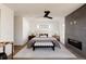 Bright main bedroom featuring a gray fireplace, wood floors, and multiple windows at 3435 W 17Th Ave, Denver, CO 80204