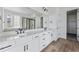 A luxurious bathroom with double vanity, modern fixtures, and walk-in closet at 25283 E Warren Pl, Aurora, CO 80018