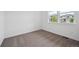 Bright bedroom featuring neutral carpet, ample natural light, and a view of the neighborhood at 25283 E Warren Pl, Aurora, CO 80018