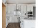 Bright kitchen featuring a new island, and modern stainless steel appliances at 25283 E Warren Pl, Aurora, CO 80018
