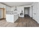 Modern kitchen featuring an island, stainless appliances, and sleek, all-white cabinetry at 25283 E Warren Pl, Aurora, CO 80018