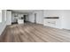 Bright, open-concept living room with wood floors and fireplace at 25283 E Warren Pl, Aurora, CO 80018