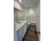 Well-lit bathroom featuring a vanity with solid surface countertop and combination shower-tub at 3909 N Shawnee St, Aurora, CO 80019