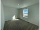 Bright bedroom featuring neutral carpet, and a window offering views at 3909 N Shawnee St, Aurora, CO 80019