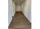 Inviting hallway with beautiful wood-look flooring leads to the front door, creating a warm and welcoming entrance at 3909 N Shawnee St, Aurora, CO 80019