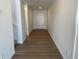 Inviting hallway with wood flooring and a clear view of the front door at 3909 N Shawnee St, Aurora, CO 80019