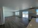 Open floor plan living room with wood flooring, large windows and natural light at 3909 N Shawnee St, Aurora, CO 80019