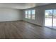 Spacious living room with light wood flooring, and large windows with views of the neighborhood at 3909 N Shawnee St, Aurora, CO 80019