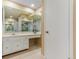 Bright bathroom featuring mirrored walls, vanity area with drawers, and a neutral color scheme at 2770 S Elmira St # 42, Denver, CO 80231
