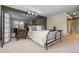 Relaxing bedroom with mirrored wall, a stylish metal bed frame with plush pillows, and artistic bedside decor at 2770 S Elmira St # 42, Denver, CO 80231