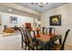 Open-concept dining room with designer chairs and striking art that flows into other living areas at 2770 S Elmira St # 42, Denver, CO 80231