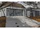 Attached two-car garage featuring a concrete driveway with a grey door for a modern look at 2770 S Elmira St # 42, Denver, CO 80231
