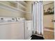 Convenient laundry room features a washer, dryer, storage shelves, and stylish accents at 2770 S Elmira St # 42, Denver, CO 80231
