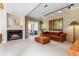 Cozy living room with a fireplace, plush seating, and a sliding glass door to an outdoor patio at 2770 S Elmira St # 42, Denver, CO 80231